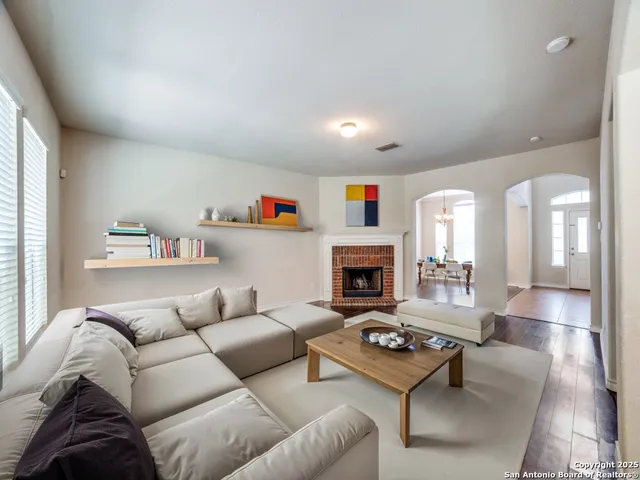 a living room with furniture and a fireplace