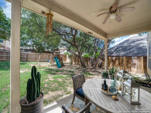 a view of a porch with furniture and a backyard