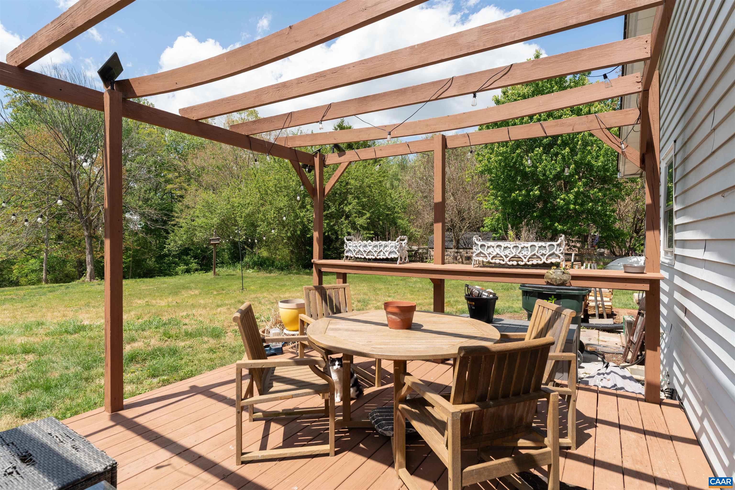 418 James River Road Scottsville, VA 24590 - Photo 33 of 61 a view of a patio with a table chairs and a backyard