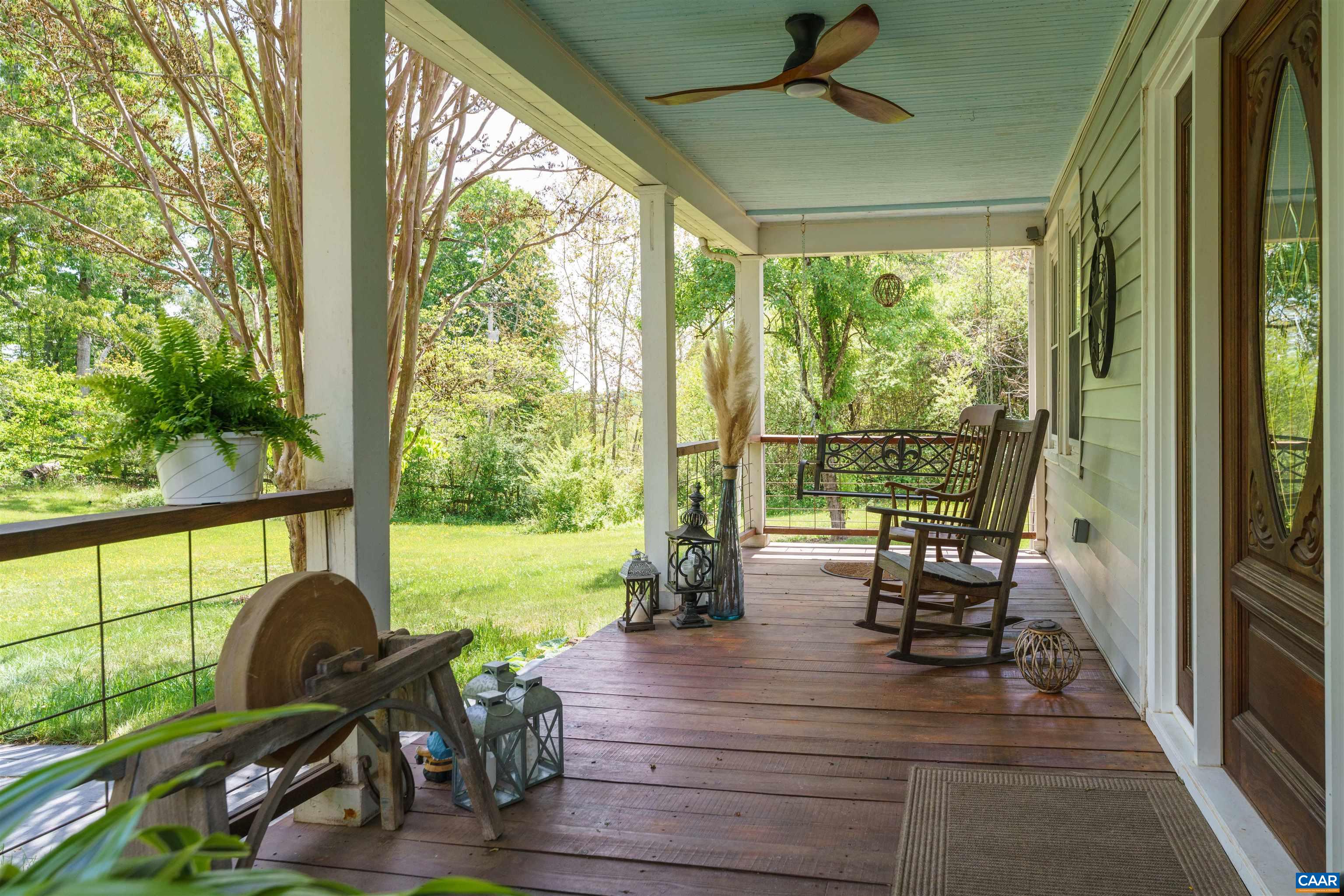 418 James River Road Scottsville, VA 24590 - Photo 8 of 61 a view of a porch with chairs and dining table