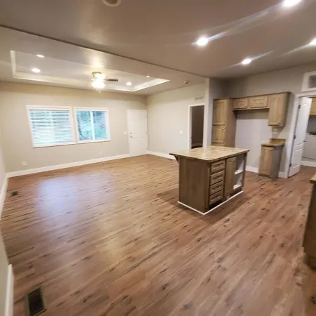 an empty room with wooden floor and fireplace