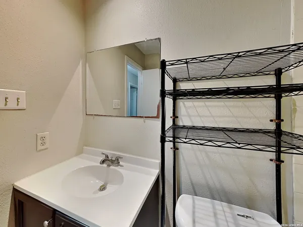 a bathroom with a sink a mirror and a toilet