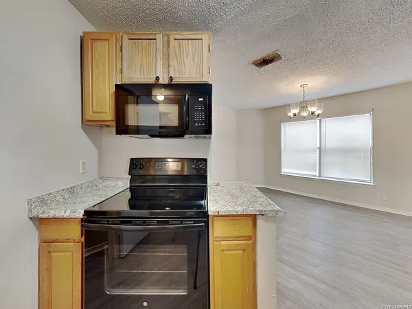 a kitchen with granite countertop stainless steel appliances sink and cabinets