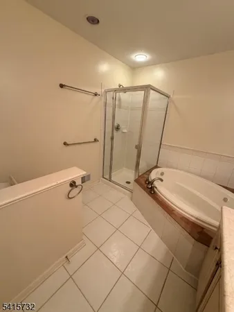 a bathroom with a tub and a shower