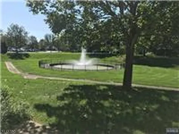 a view of a park with large trees