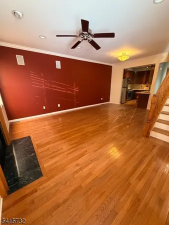 a view of kitchen and hall with wooden floor