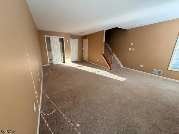 a view of an empty room with windows
