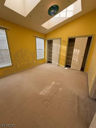 a view of an empty room with a fireplace