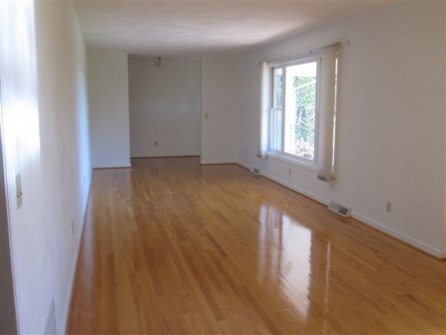 3778 Callaway Road Rocky Mount, VA 24151 - Photo 4 of 28 an empty room with wooden floor and windows