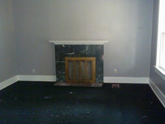 3172 Hoskins Road Memphis, TN 38111 - Photo 6 of 15 Unfurnished living room featuring baseboards and a fireplace with flush hearth