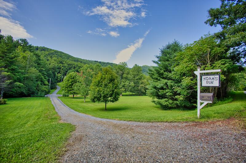 1199 Brammer Spur Road Woolwine, VA 24185 - Photo 3 of 36 a view of a house with a big yard and a large trees
