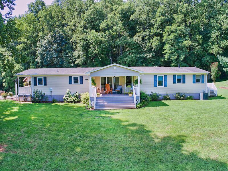 1199 Brammer Spur Road Woolwine, VA 24185 - Photo 9 of 36 a front view of a house with a yard and trees