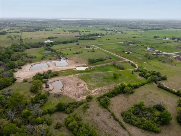 an aerial view of a houses with outdoor space