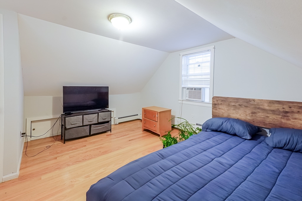 5 Oliver Street Randolph, MA 02368 - Photo 26 of 29 a bedroom with furniture and a flat screen tv