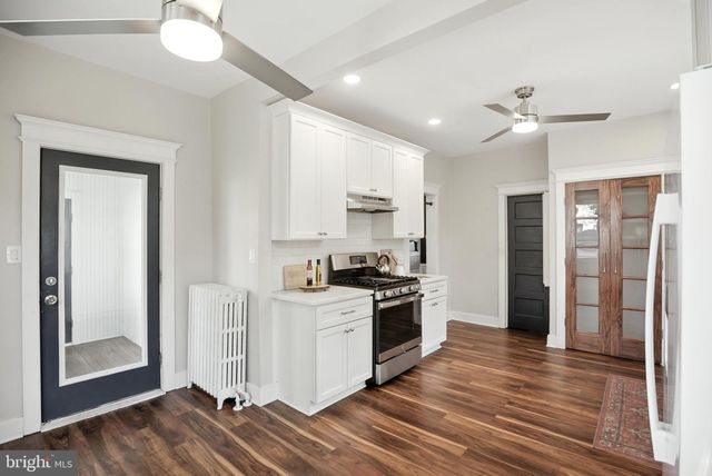a kitchen with stainless steel appliances granite countertop a stove and a refrigerator