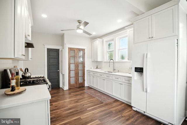 a kitchen with stainless steel appliances a sink stove and refrigerator