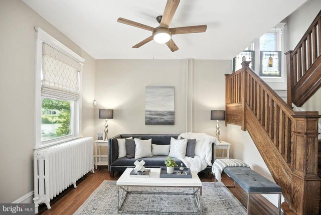 a living room with furniture a rug and a table