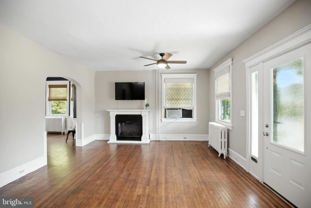 a view of an empty room with a fireplace and a window