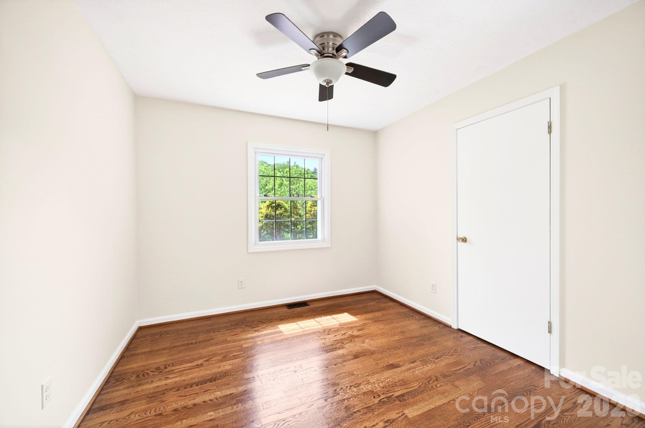 34 Wolfe Cove Road Asheville, NC 28804 - Photo 16 of 42 an empty room with a window and a ceiling fan