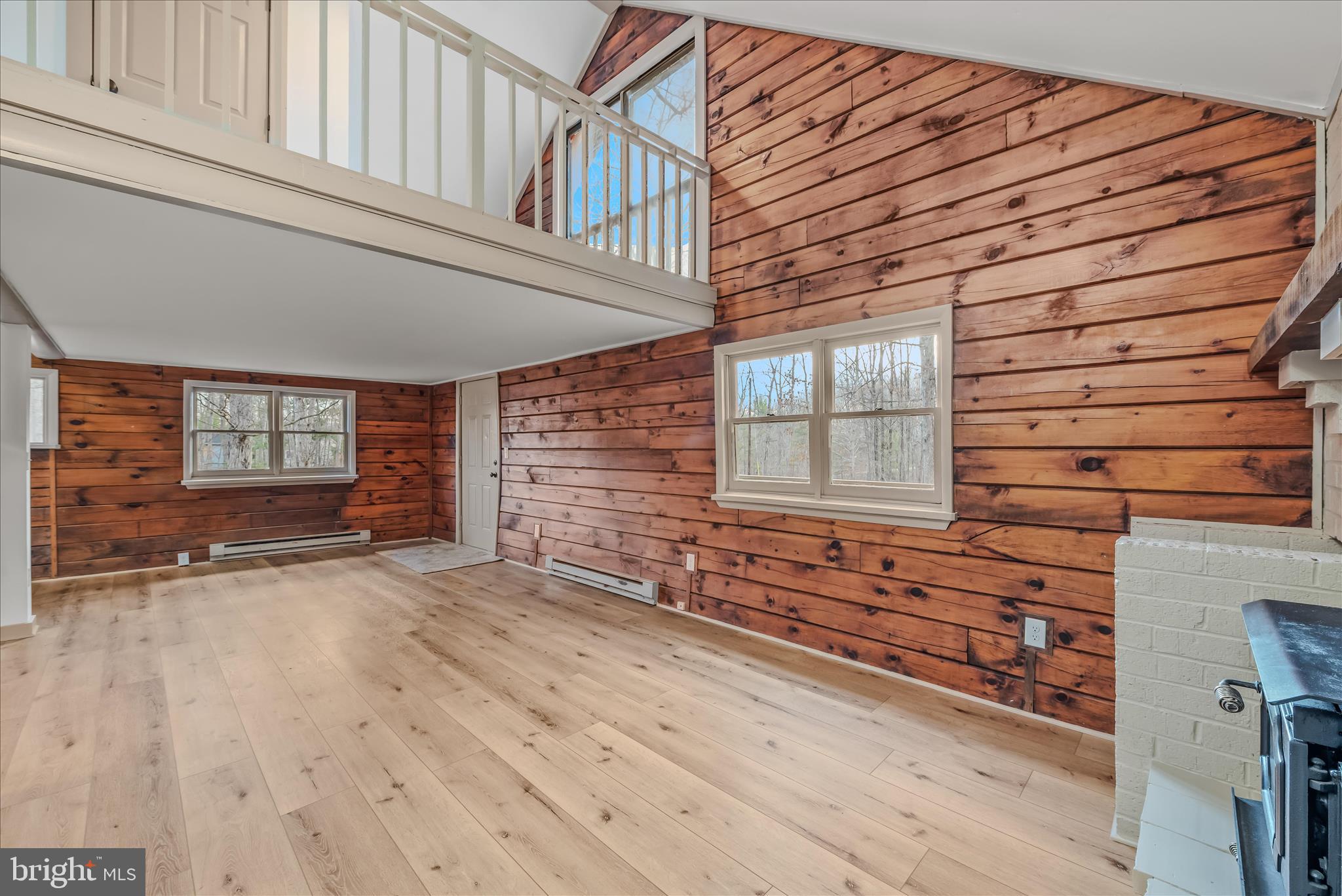 495 Getaway Road Hedgesville, WV 25427 - Photo 12 of 44 an empty room with wooden floor and windows