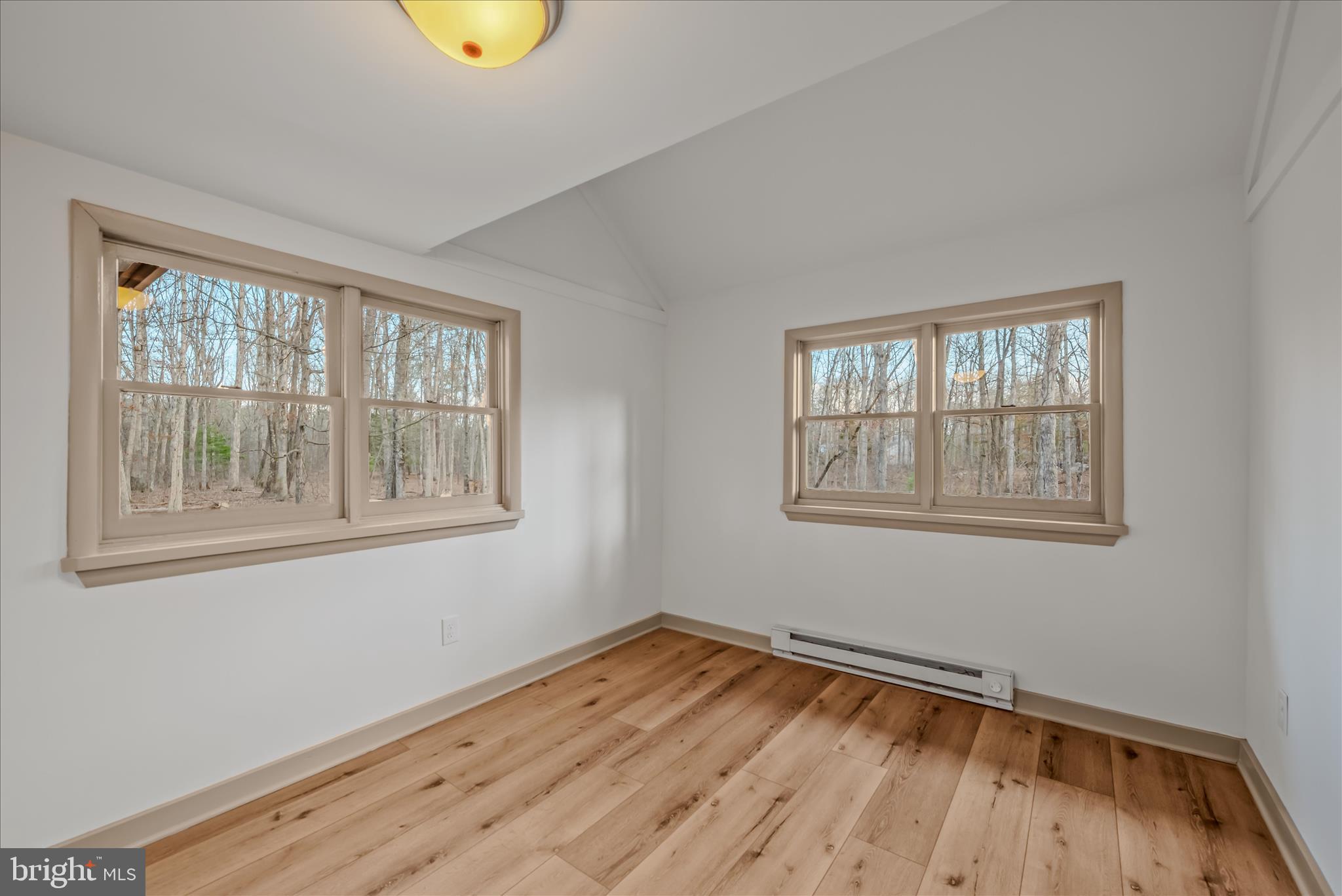 495 Getaway Road Hedgesville, WV 25427 - Photo 15 of 44 a view of empty room with wooden floor and fan