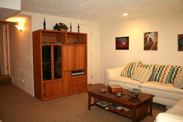 23 Highfield Road, Unit D Charlton, MA 01507 - Photo 11 of 24 a living room with furniture a refrigerator and a sink