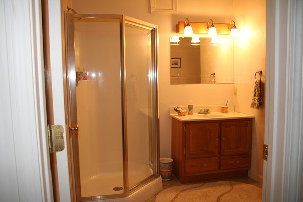 23 Highfield Road, Unit D Charlton, MA 01507 - Photo 14 of 24 a bathroom with a sink and a mirror