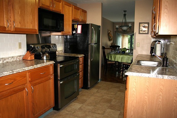 23 Highfield Road, Unit D Charlton, MA 01507 - Photo 2 of 24 a kitchen with a refrigerator and a sink