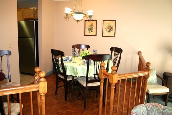 23 Highfield Road, Unit D Charlton, MA 01507 - Photo 6 of 24 a view of a dining room with furniture and a chandelier