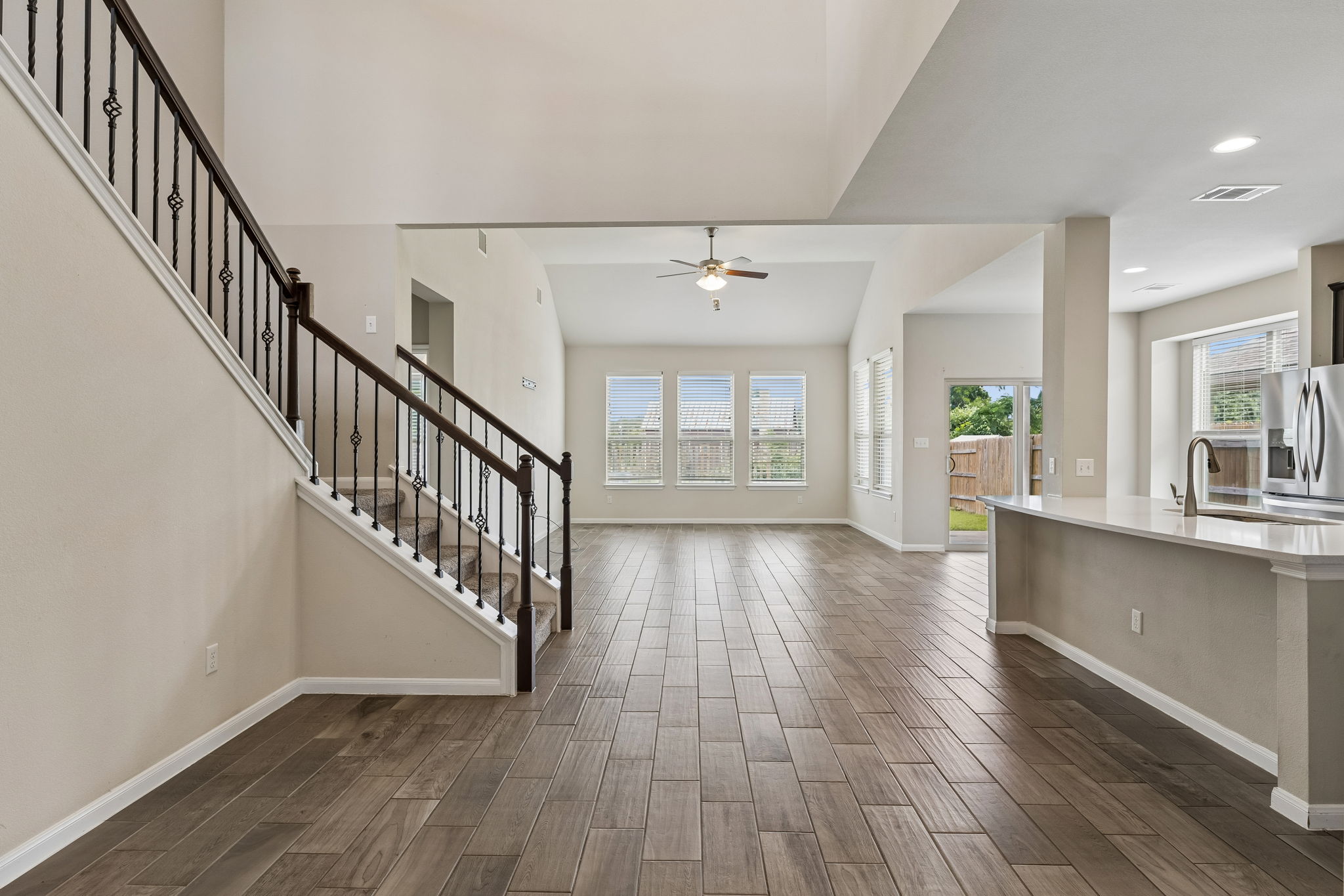 301 Rimrock Court Bastrop, TX 78602 - Photo 5 of 21 An open-concept main living area with high ceilings and wood-look tile flooring awaits your personal touch.