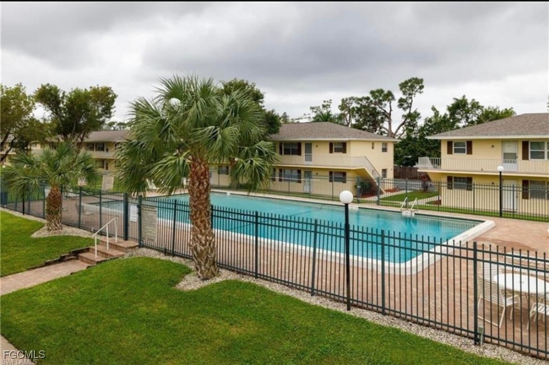 3325 Airport Road North, Unit L2 Naples, FL 34105 - Photo 1 of 14 a view of a house with backyard and a tree