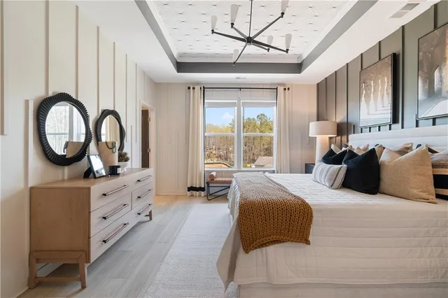 a spacious bedroom with a large bed and a window