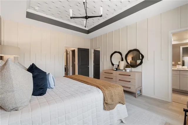 a bedroom with bed and a potted plant