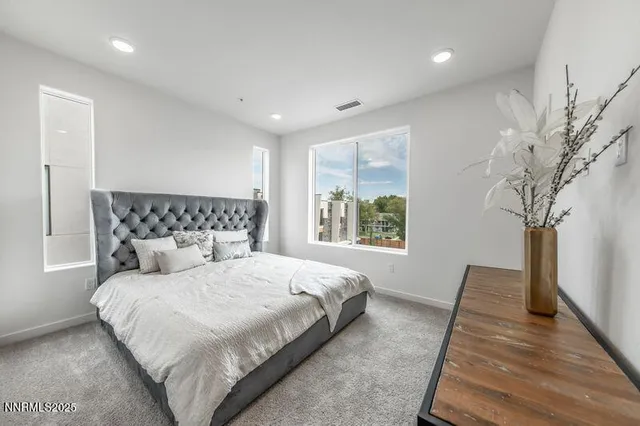 a bedroom with a large bed and a window