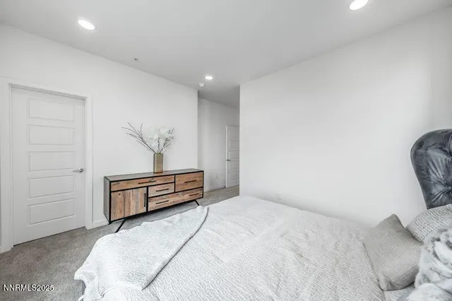 a bedroom with a bed and a chair