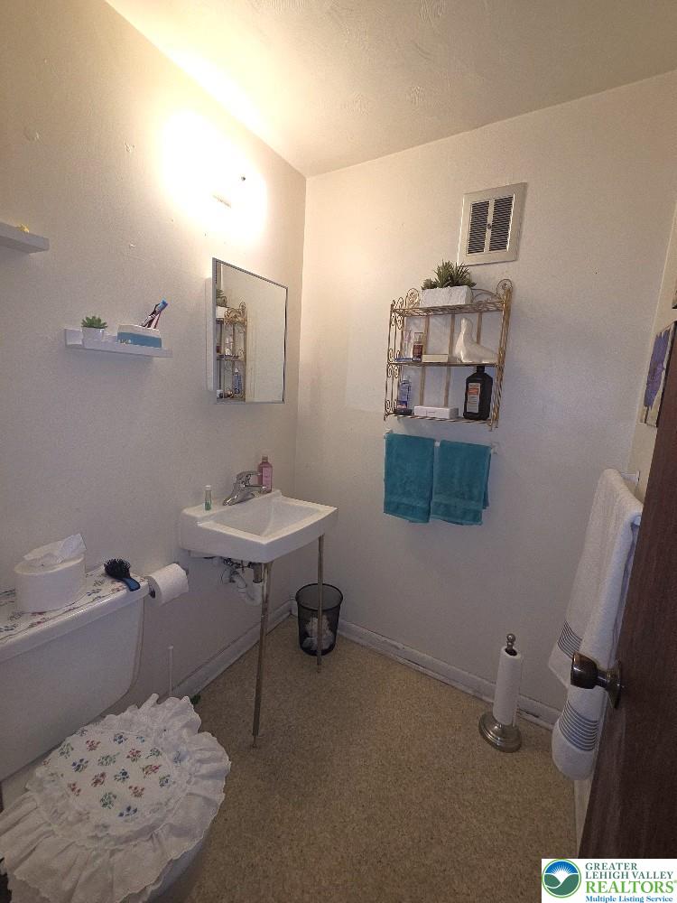 41 South 4th Street Allentown, PA 18102 - Photo 15 of 19 a bathroom with a sink toilet and a mirror