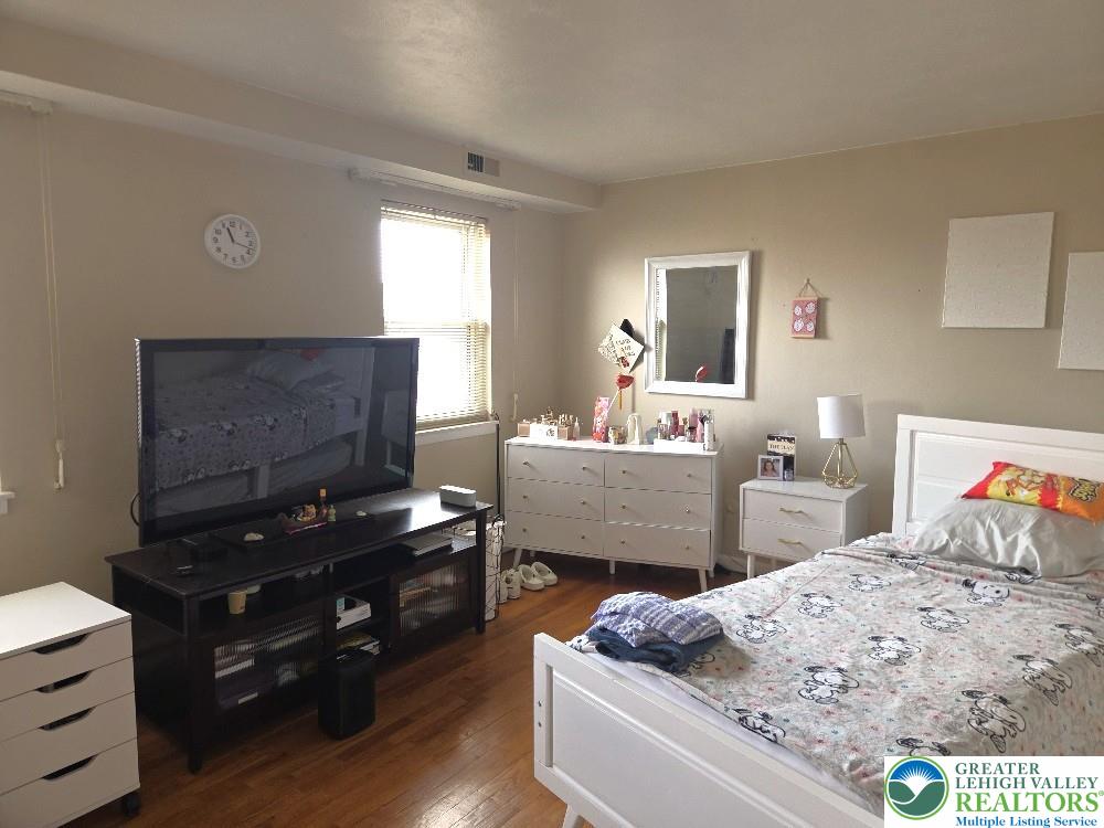41 South 4th Street Allentown, PA 18102 - Photo 16 of 19 a bedroom with furniture and a mirror