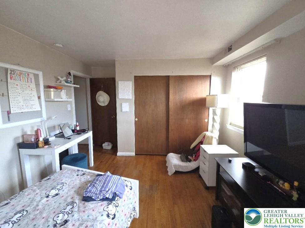 41 South 4th Street Allentown, PA 18102 - Photo 17 of 19 a bedroom with a bed and wooden floor