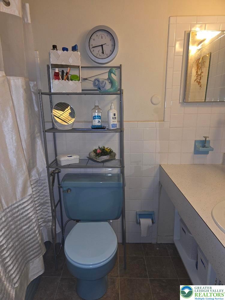 41 South 4th Street Allentown, PA 18102 - Photo 18 of 19 a bathroom with a toilet sink and vanity