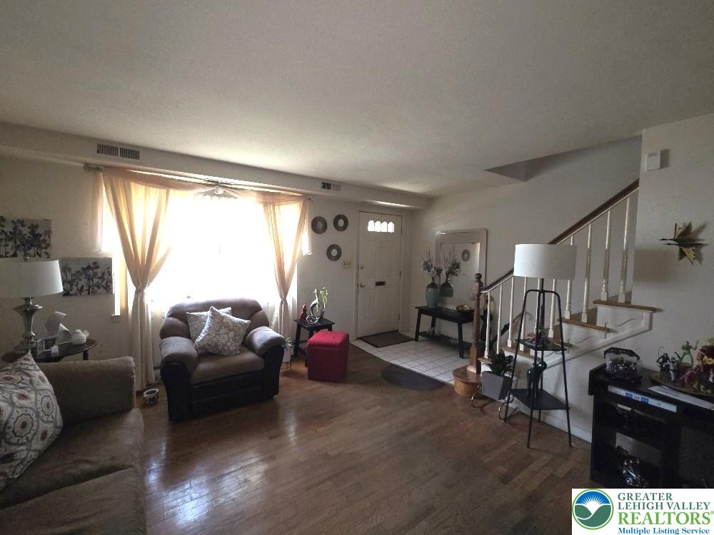 41 South 4th Street Allentown, PA 18102 - Photo 4 of 19 a living room with furniture a window and gym equipment