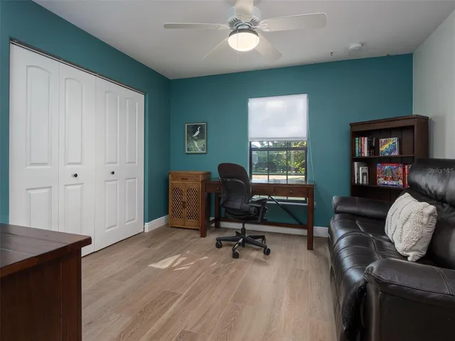 a view of a livingroom with workspace and a window