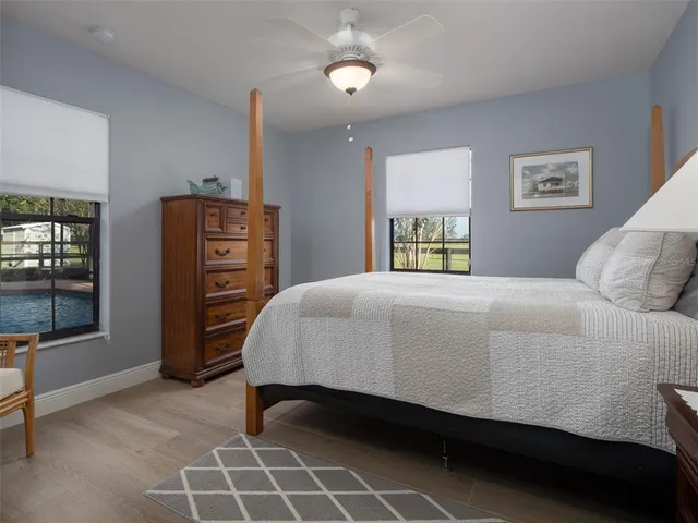 a bedroom with a bed and a lamp on dresser