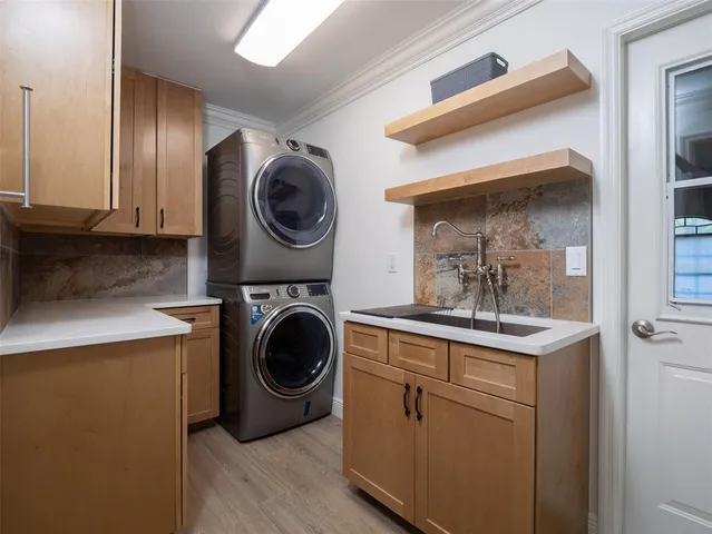 a utility room with sink dryer and washer