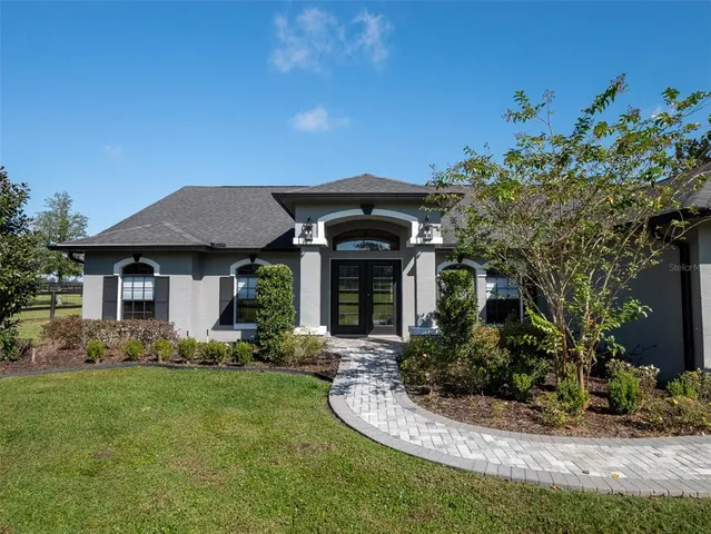 a front view of a house with a garden