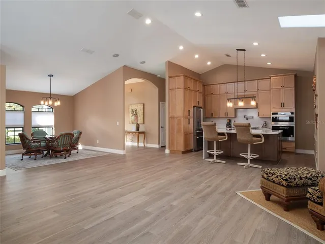 a living room with furniture and kitchen view