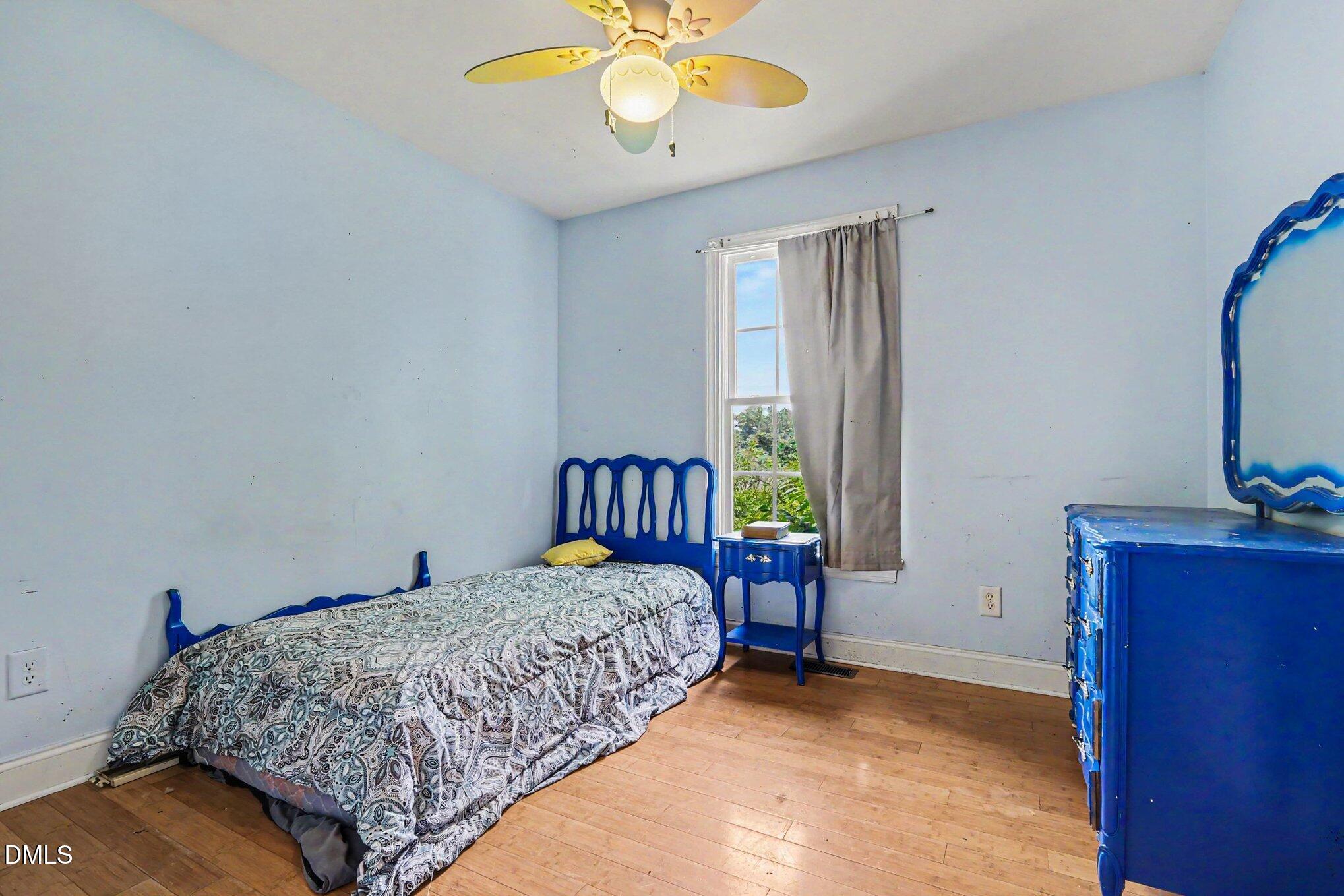 1750 Tom Oakley Road Timberlake, NC 27583 - Photo 14 of 31 a bedroom with a bed and a chandelier