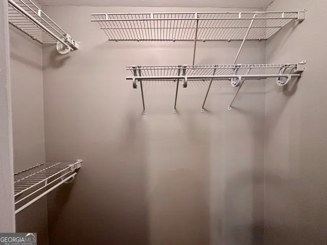 a bathroom with a granite countertop sink and a large mirror