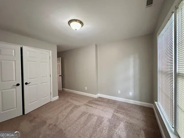 an empty room with closet area