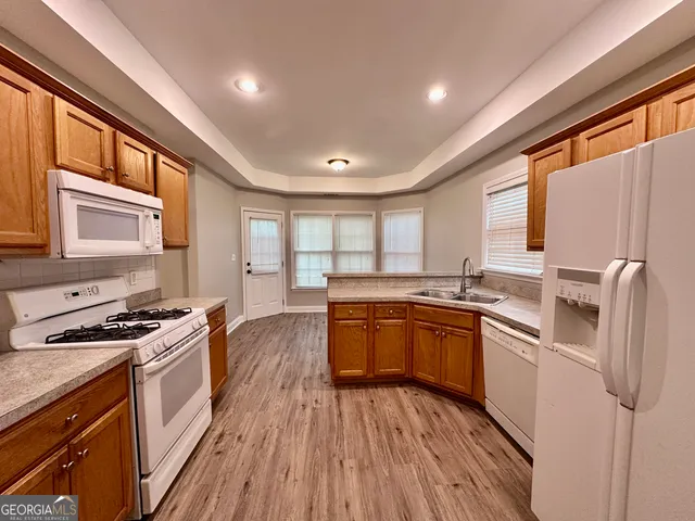 a bathroom with a granite countertop toilet sink and mirror