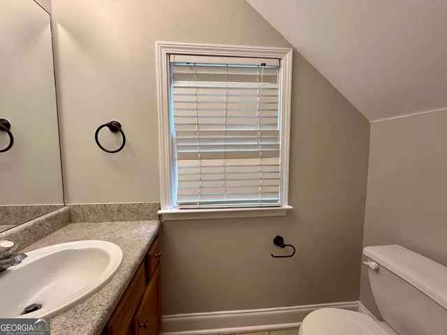 a view of a wooden fence and trees